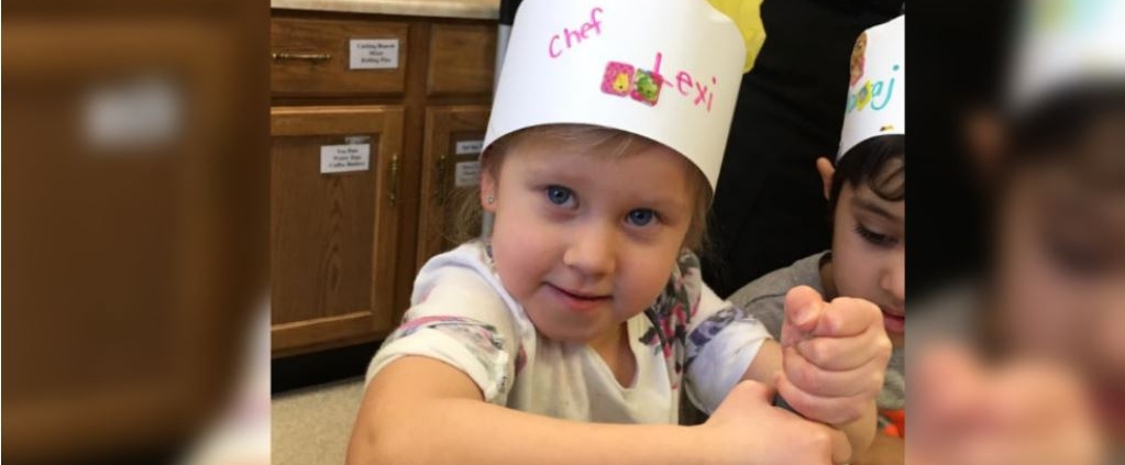 a photo of a girl wearing a chef hat